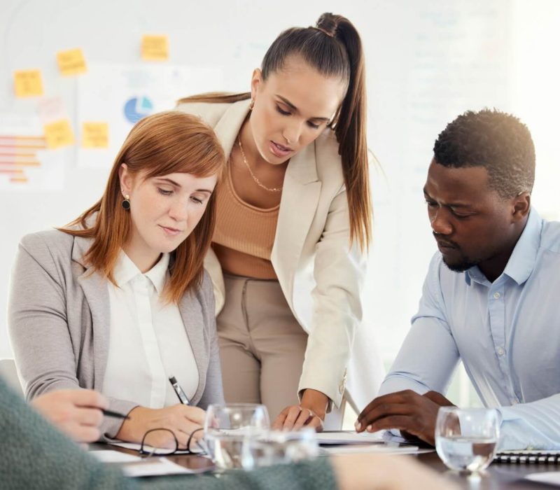 business-people-financial-and-meeting-at-a-table-with-serious-workers-planning-writing-and-prepar.jpg